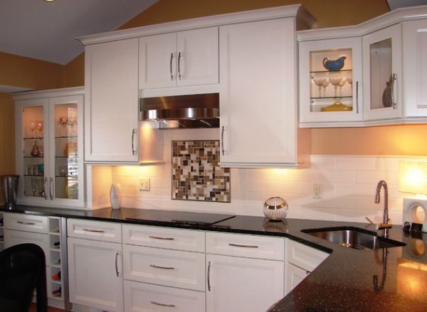 Compact-corner-sink-in-a-kitchen-with-dark-countertop-and-white-cabinets