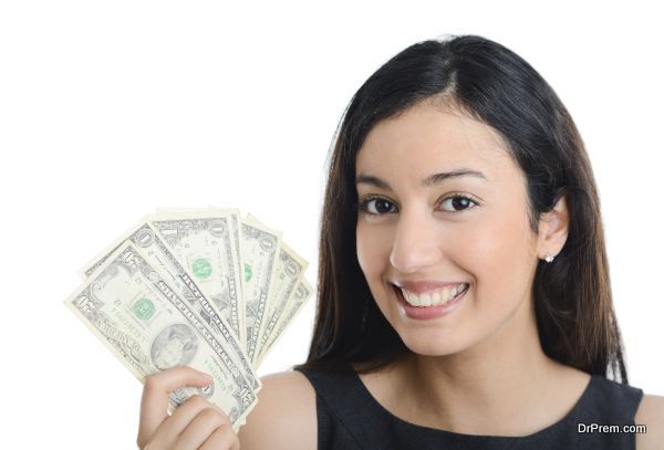isolated portrait of beautiful and successful young business woman holding dollar bills