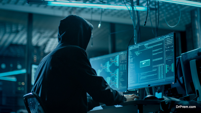 Hooded Hacker Breaking into Corporate Data