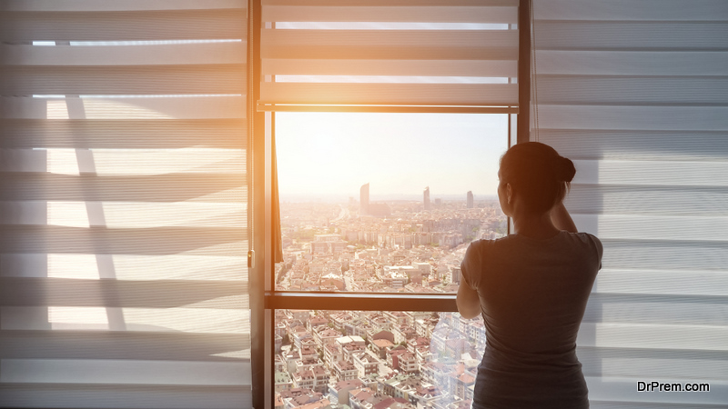 Woman is opening blinds