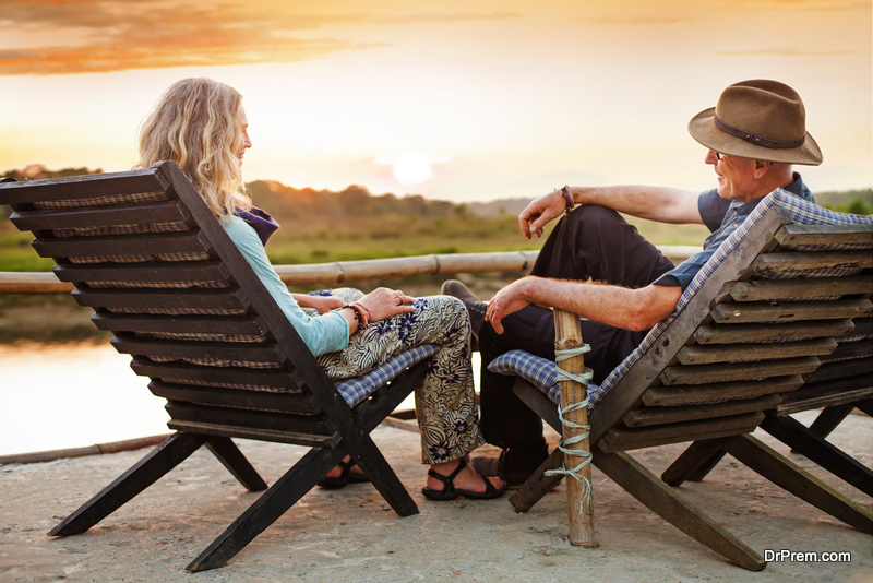 Senior european couple seating on chaise lounge