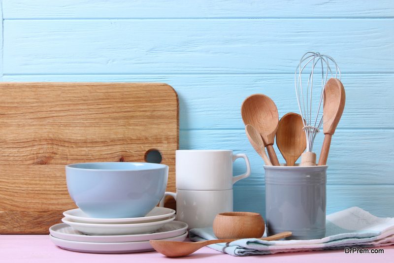 A set of dishes and kitchen utensils on a colored background