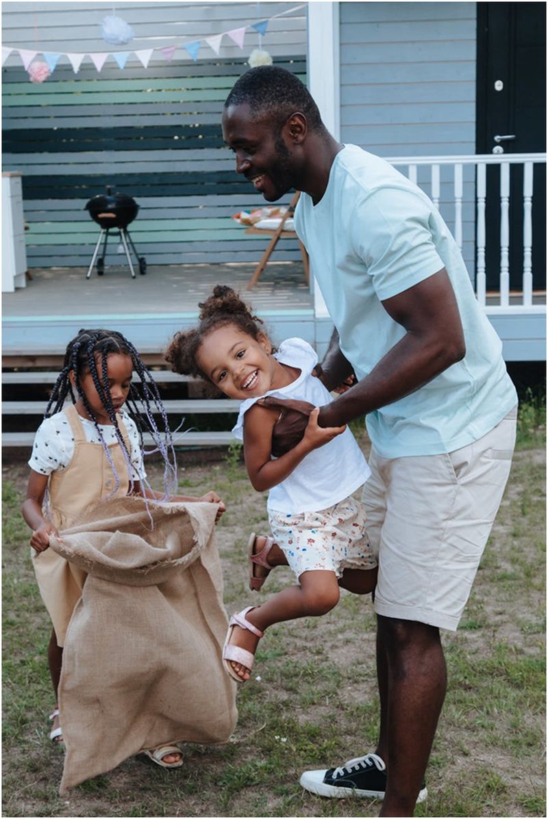 man-in-white-shirt-carrying-a-girl