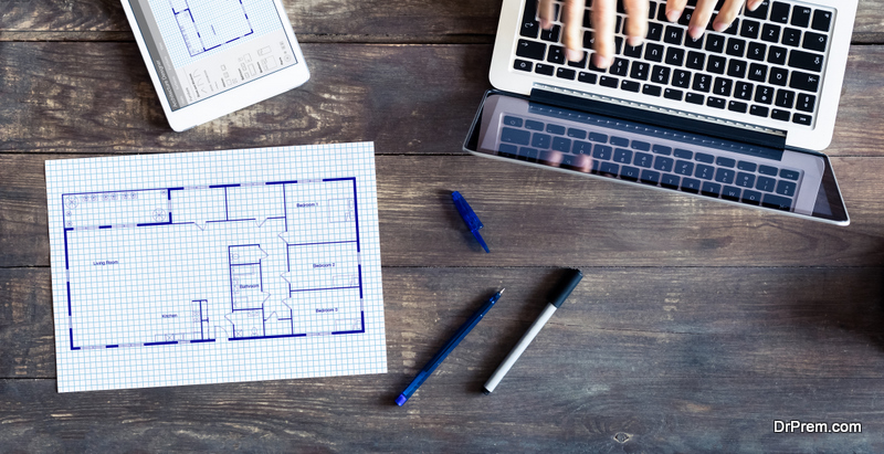 Floor plan drawing with architect designing home on computer, old wooden desk with blueprint of house or apartment project