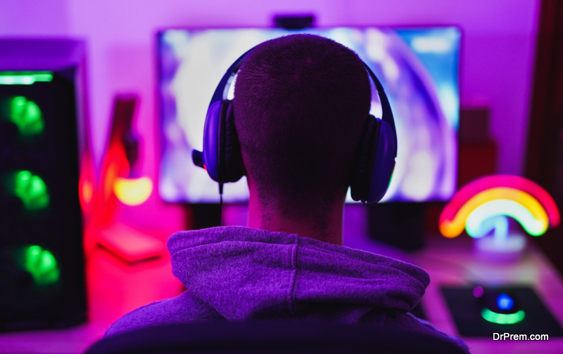 Young man wearing headset and play computer video games online 