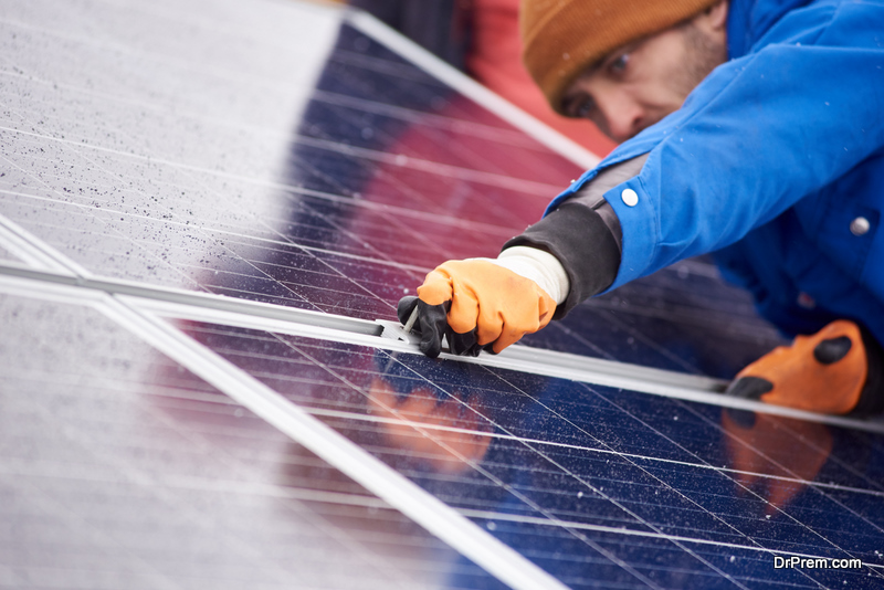 professional male electrician repairing solar panels 